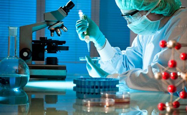 workers testing filling sealing samples اختبار-معملي-باستخدام-آلة-حشو-الأنابيب-والختم.jpg