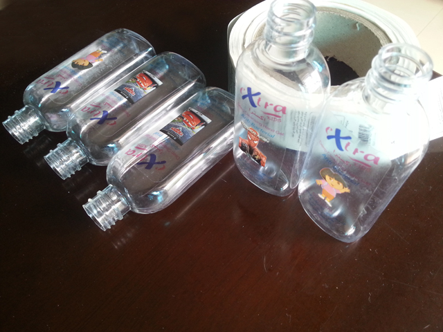 transparent labels labelled samples bottles plane surface عينة من ملصقات وزجاجات شفافة من شركة مروان (3).jpg